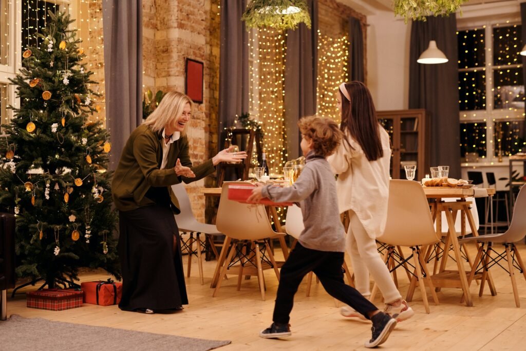 grandmother welcoming grandchildren for Christmas dinner