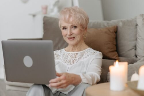 White lady working on a laptop. the peace of mind of those who chose the best cleaning services company in the Cape Cod region